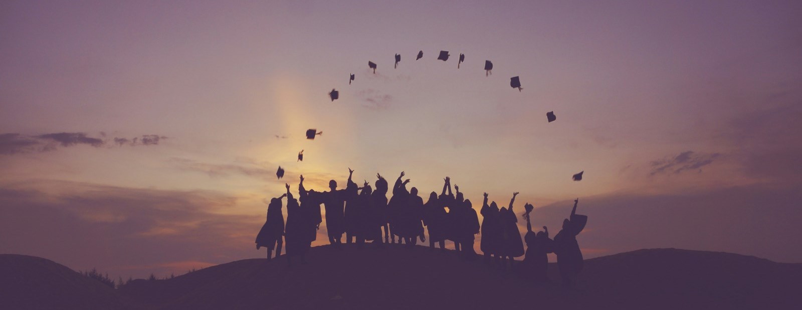 Students throwing up graduation caps