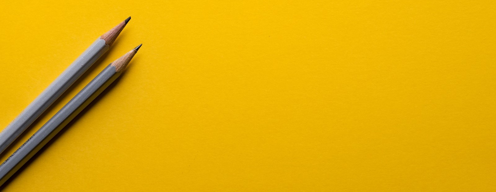 Yellow wallpaper and pencils